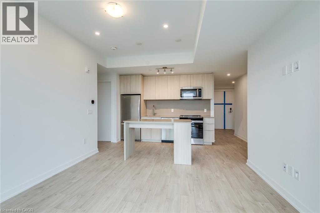 A spacious kitchen with a dining table and a refrigerator.