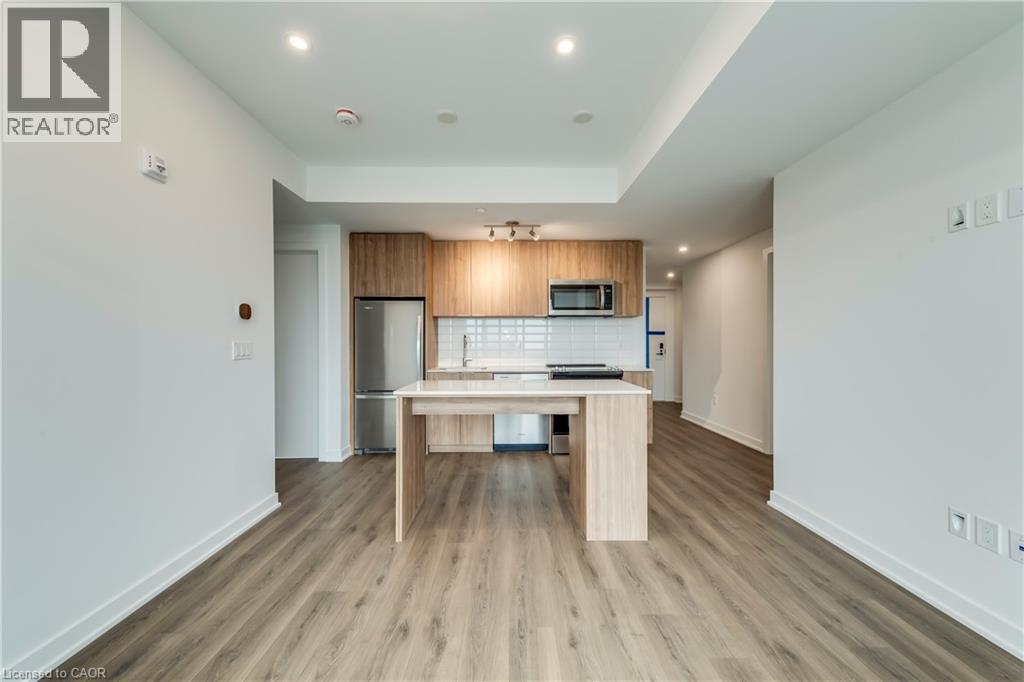 A modern kitchen with a wooden table and chairs.