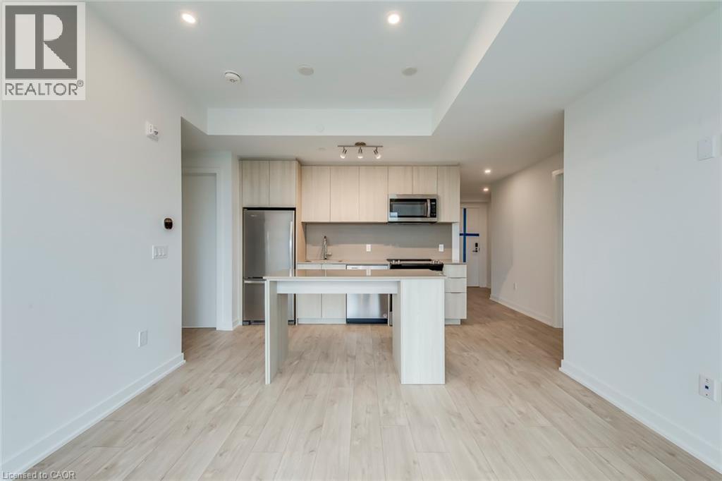 A spacious kitchen with white cabinets and a center island.