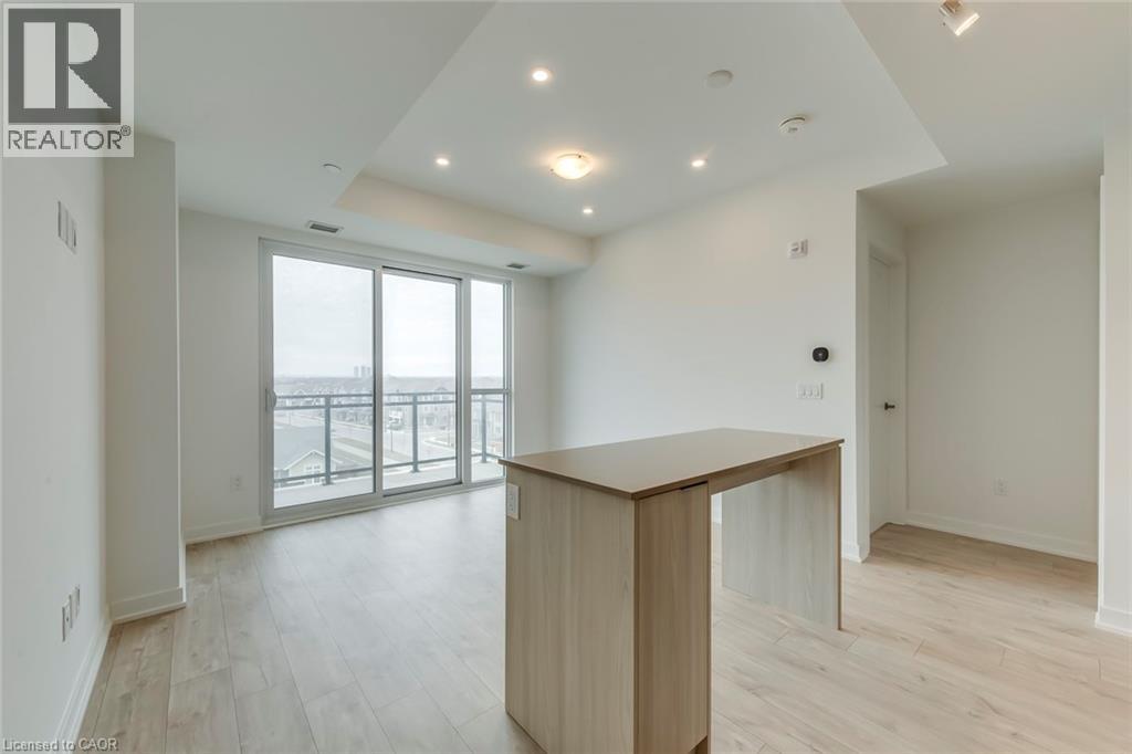A spacious room with a wooden cabinet and sliding glass doors leading to a balcony.