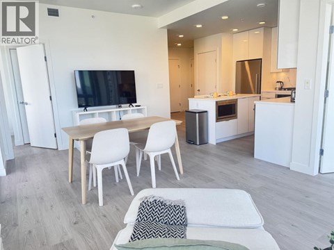 A modern living room with a white couch and a television.
