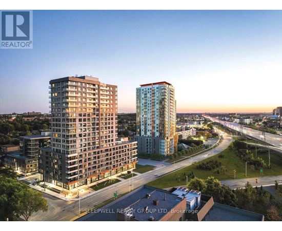 Two high-rise buildings are shown in an aerial view with a roadway in front of them.