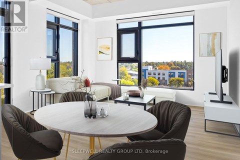 A modern living room with a large table and chairs.