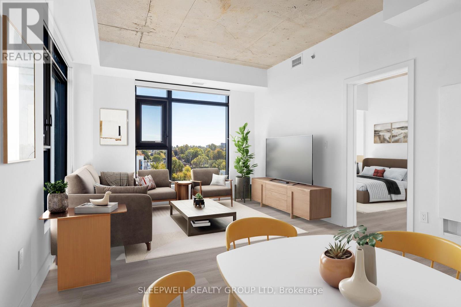 A modern living room with a large window and a flat screen TV.