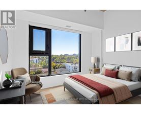 A bedroom with a large bed and a view of the city.