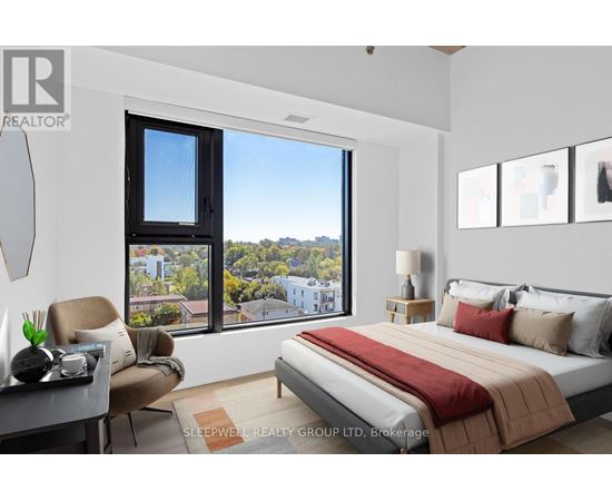 A bedroom with a large bed and a view of the city.