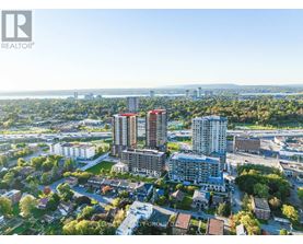 A bird's eye view of a city with apartment buildings and a bridge in the distance.