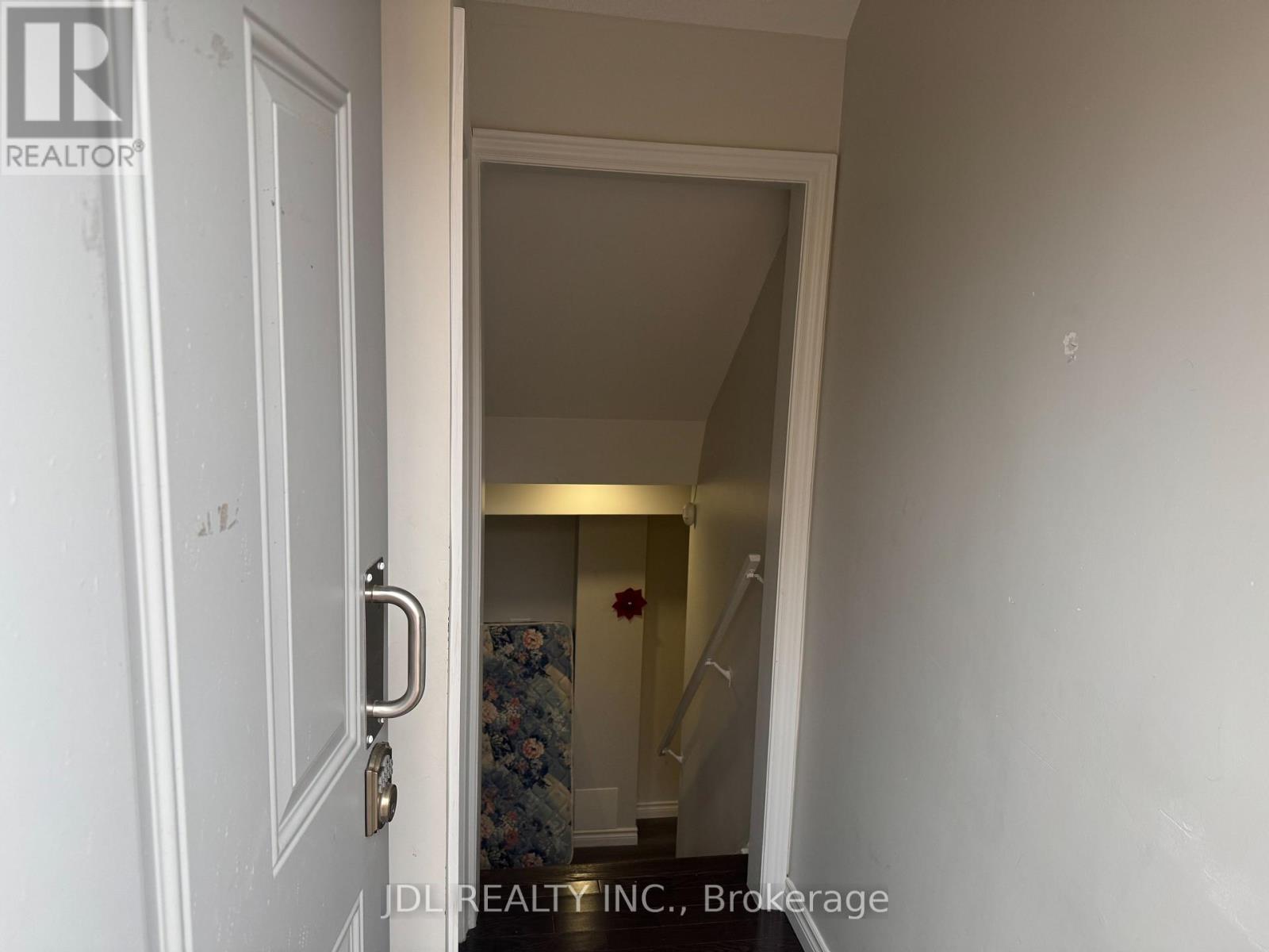 A white door with a key in the lock.