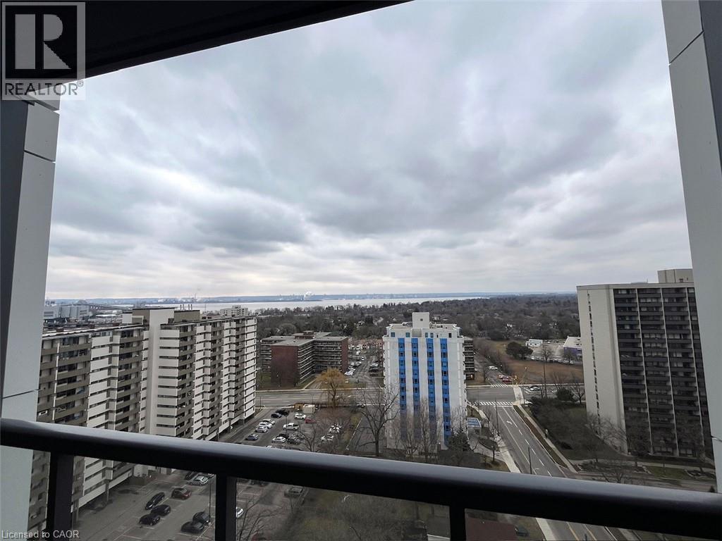 A view from a high-rise building looking out over a cityscape with a mix of residential and commercial buildings.