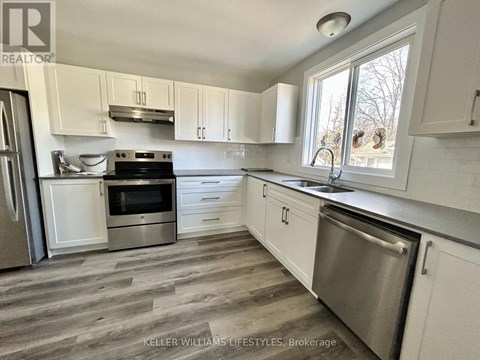 A kitchen with white cabinets and a stainless steel dishwasher.