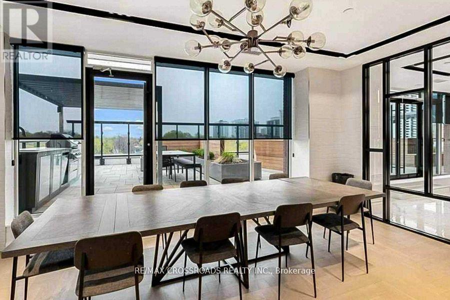 A dining room with a large table and chairs.