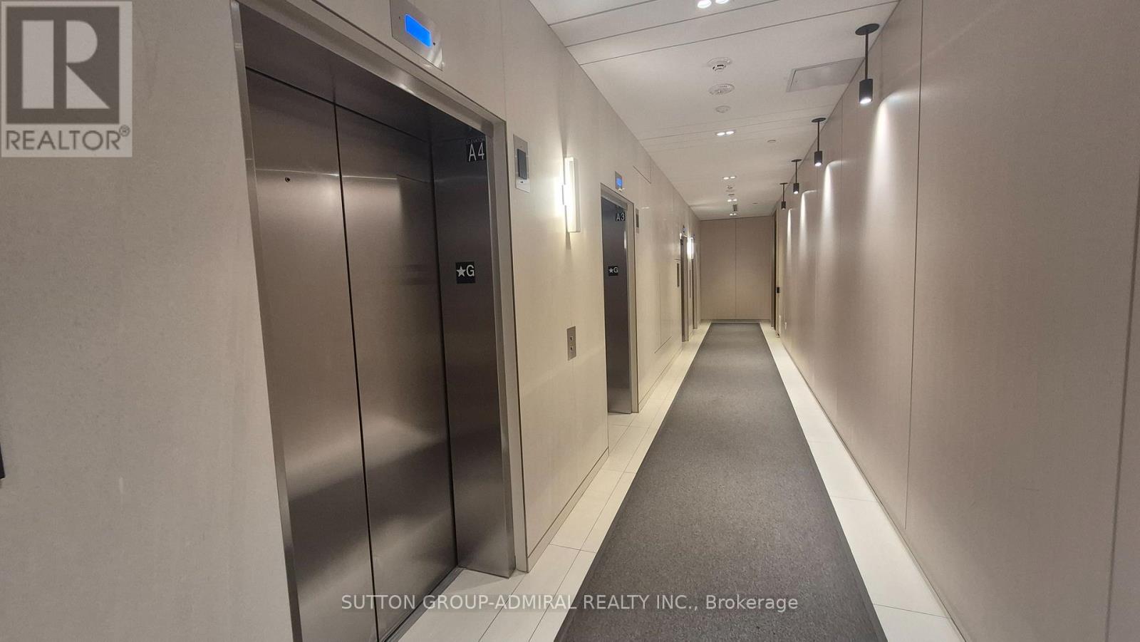 A long hallway with elevators on the left and right.