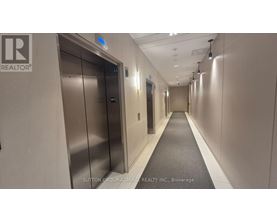 A long hallway with elevators on the left and right.