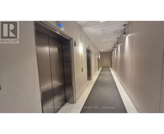 A long hallway with elevators on the left and right.