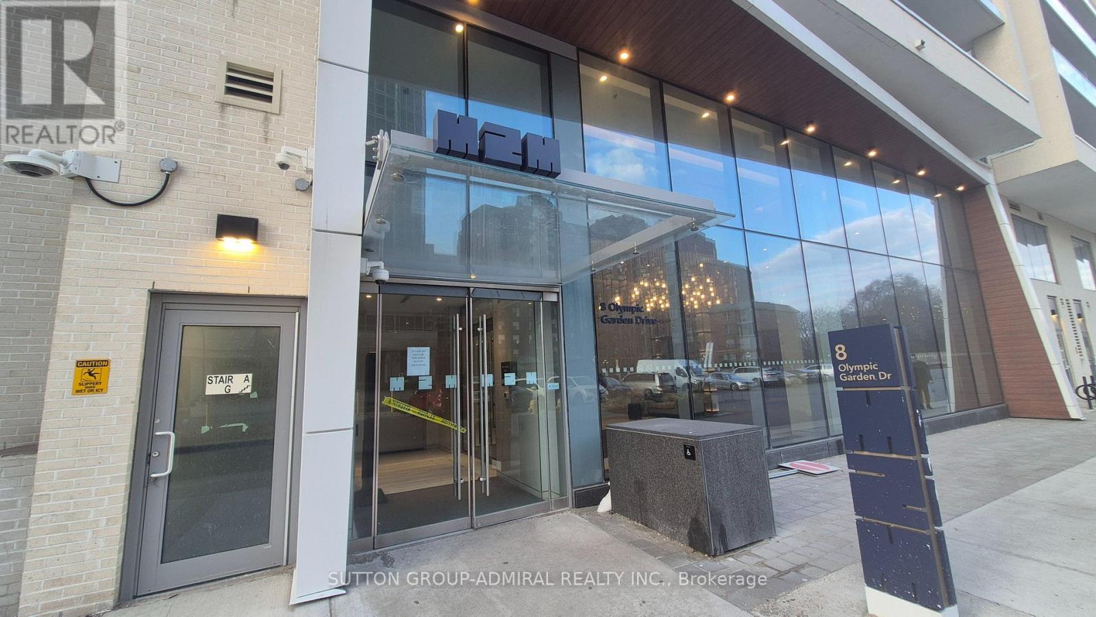 The image shows the front of a realty company named Sutton Group.