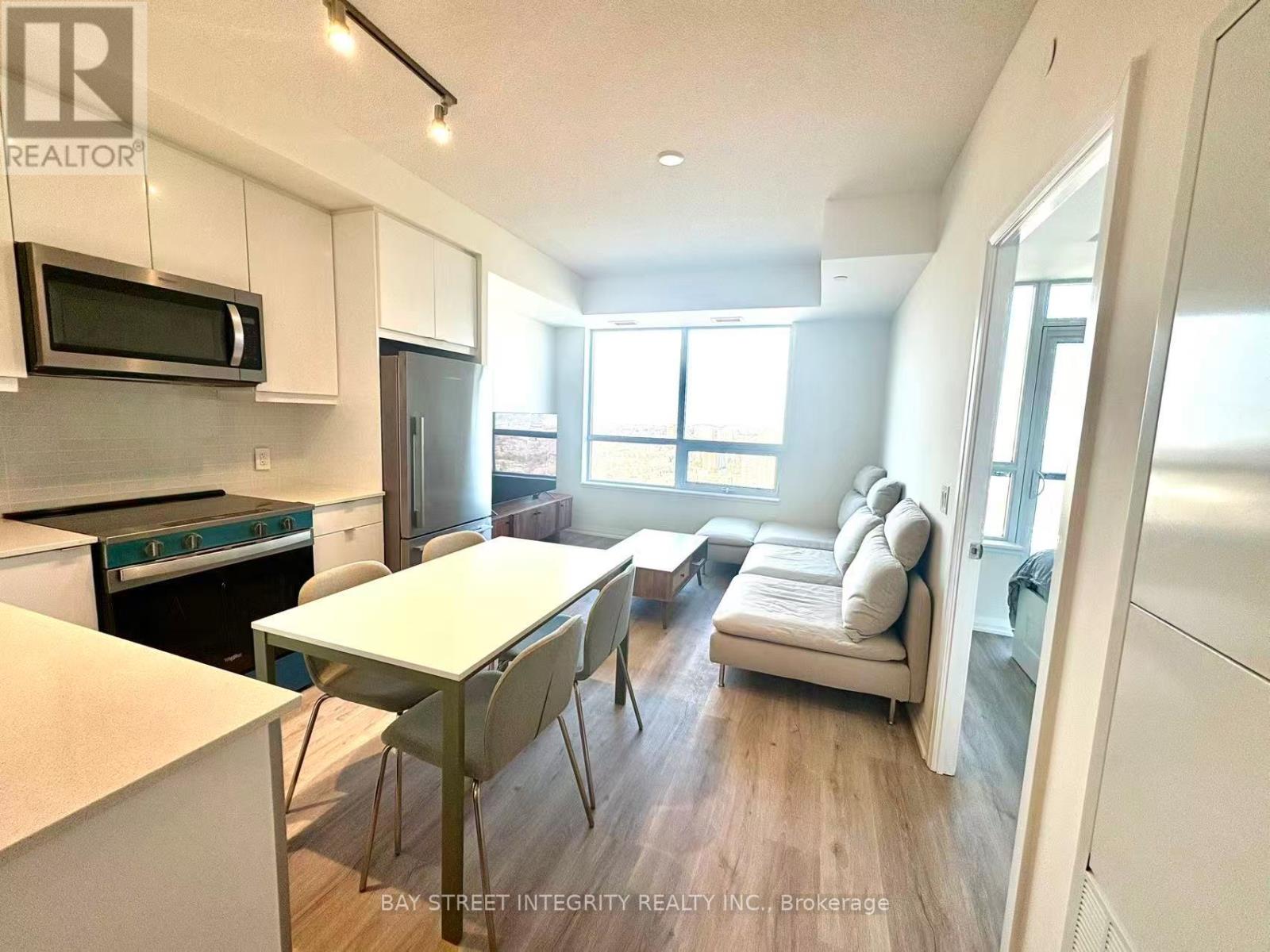 A kitchen with white cabinets and a black stove top oven.