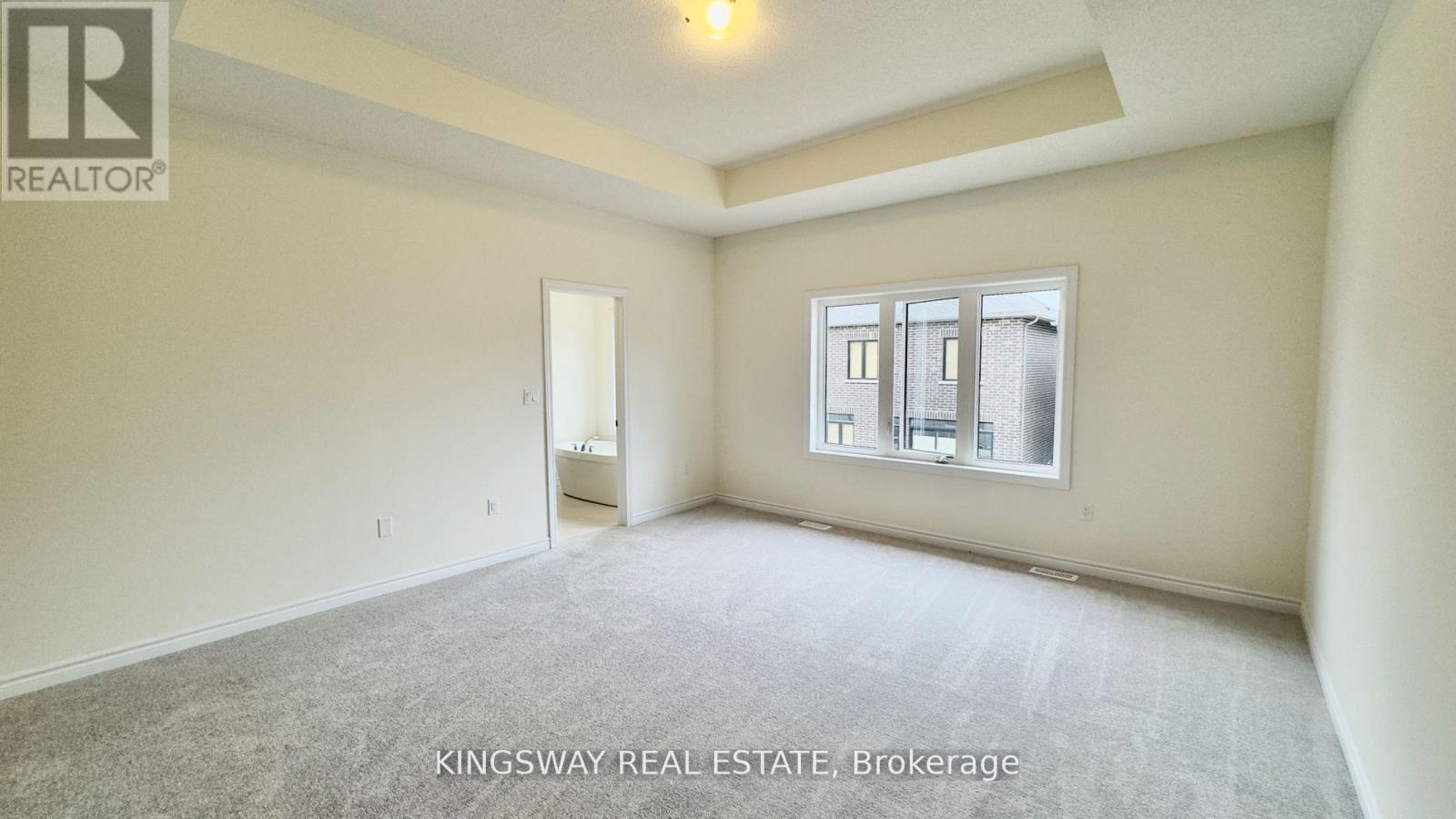 A spacious room with a window and a door is on the market with Kingsway Real Estate.