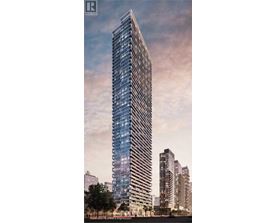 A tall, modern skyscraper with a glass facade stands prominently in a cityscape.