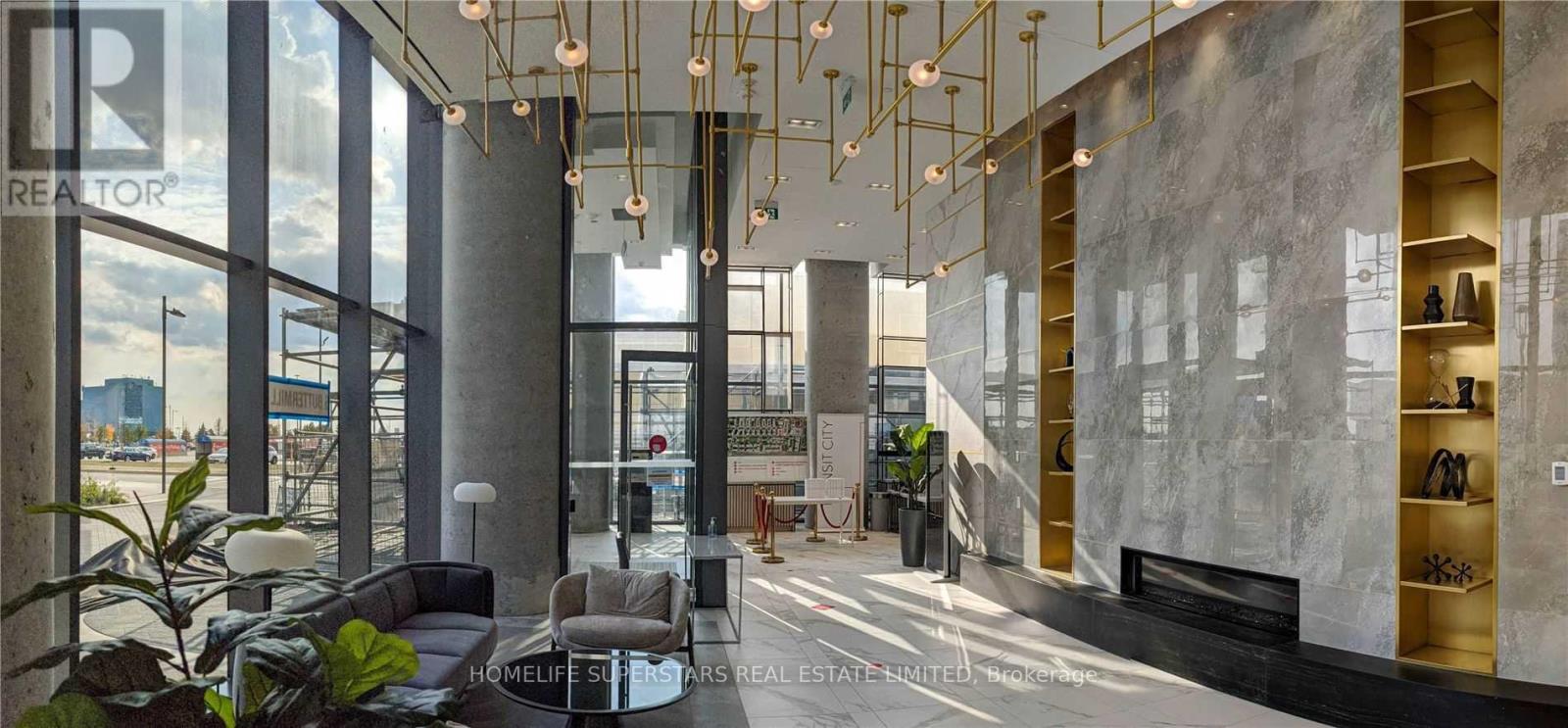 A modern interior space with a reception desk and a staircase.