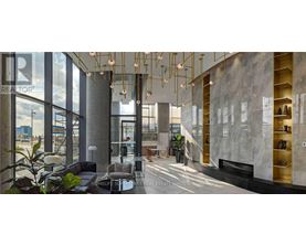 A modern interior space with a reception desk and a staircase.