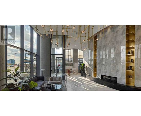 A modern interior space with a reception desk and a staircase.