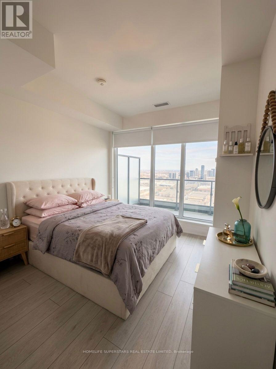 A bedroom with a large bed and a view of the city.