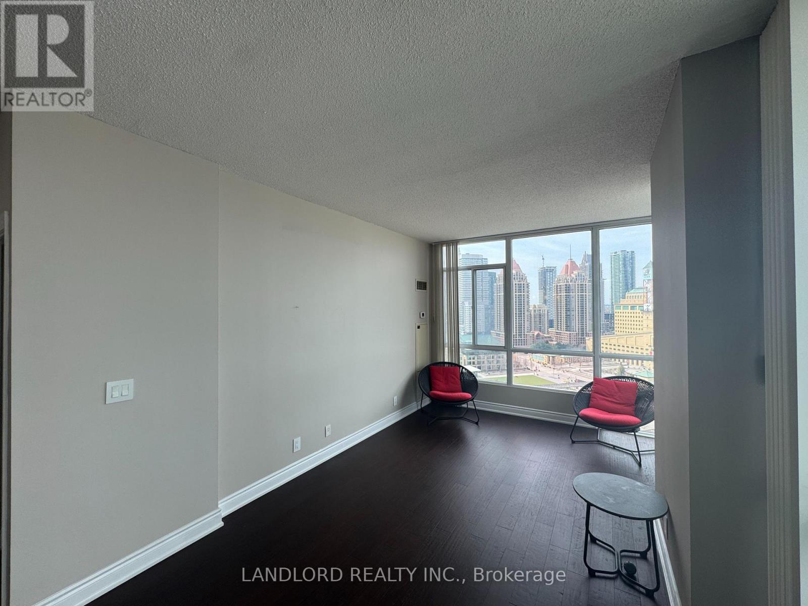 A room with a view of the cityscape through the windows.