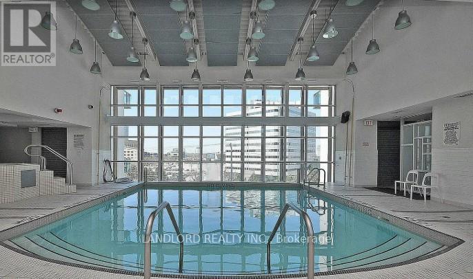 A pool inside a building with the words "landlord realty" written on the side.