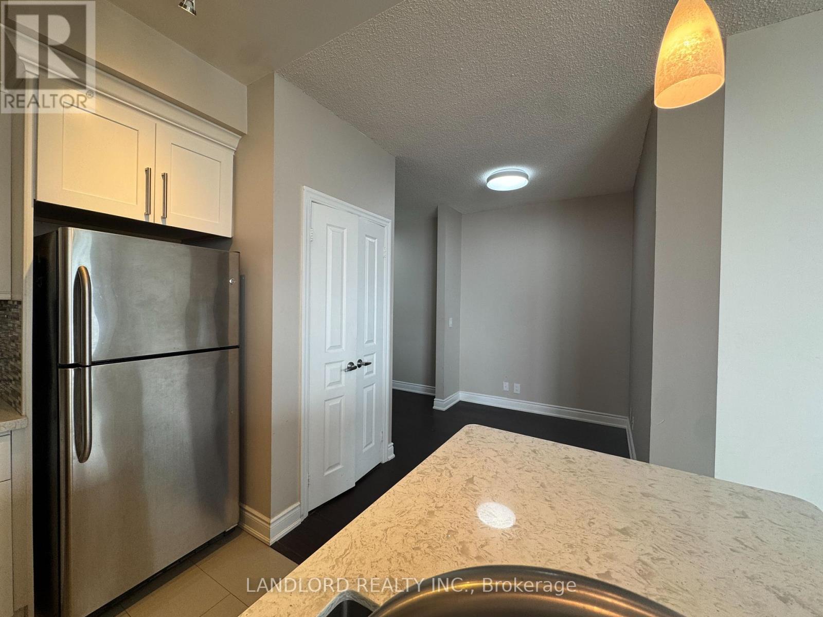 A kitchen with a refrigerator and a countertop.