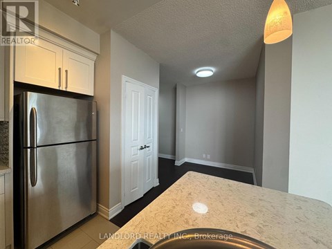 A kitchen with a refrigerator and a countertop.