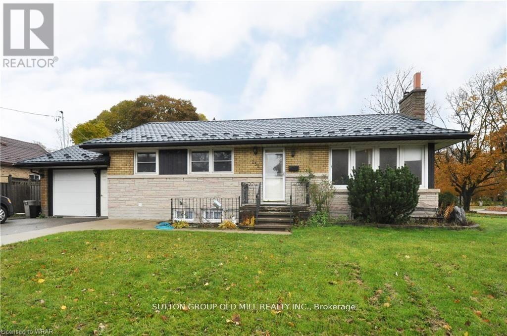 A house with a black roof and a white garage door.