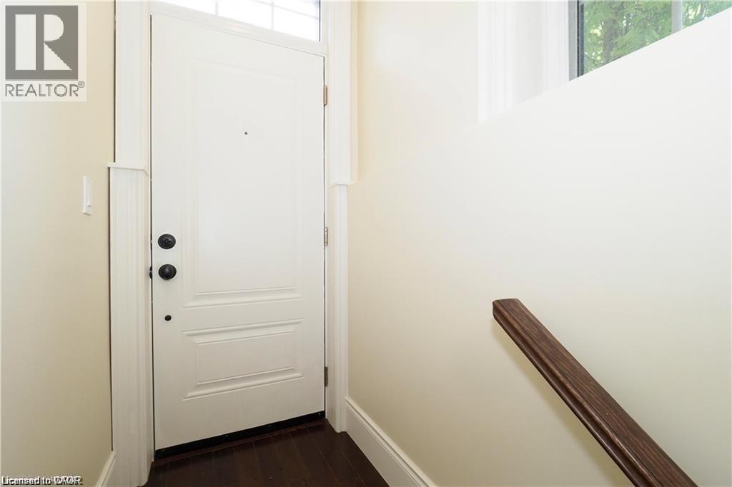A white door with a black handle is in a room with white walls.