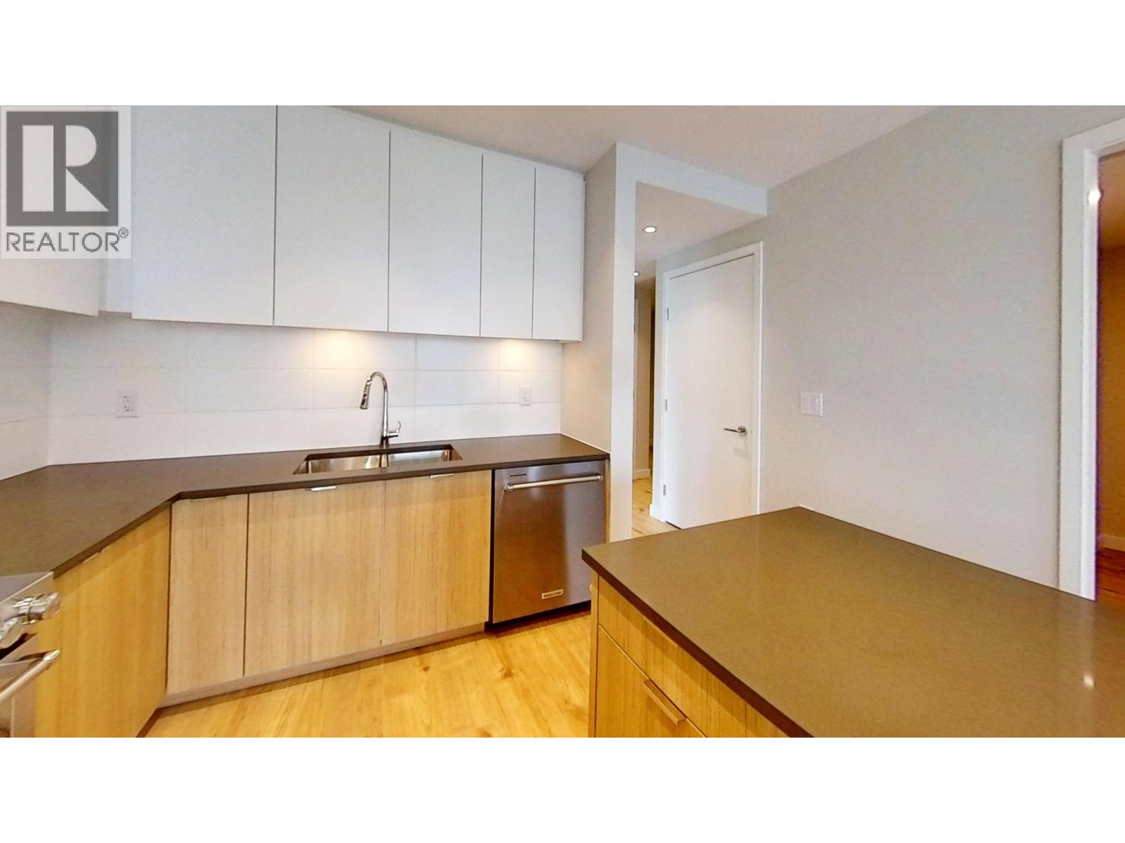A kitchen with wooden cabinets and a sink.