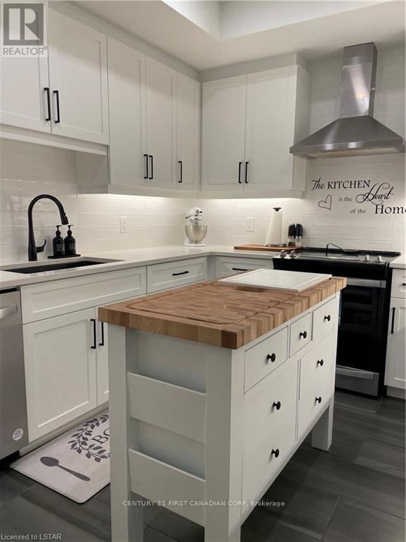 A kitchen with a wooden top counter and white cabinets.