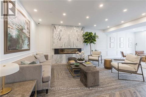 A living room with a grey sofa, a coffee table, and a large painting on the wall.