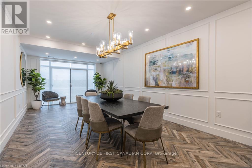 A dining room with a large table and chairs.