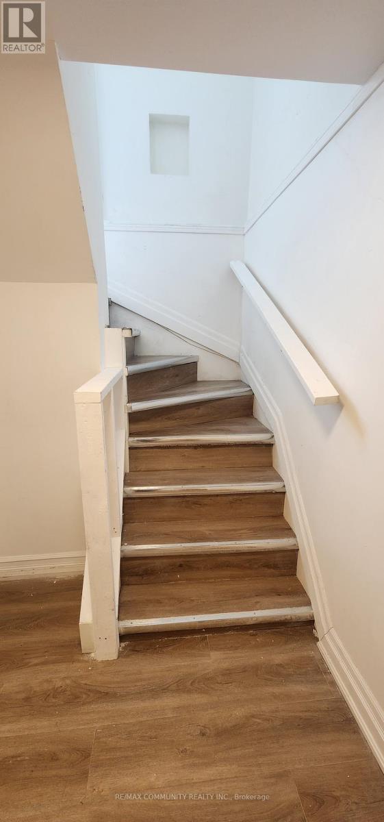 A staircase with wooden steps and white railings.