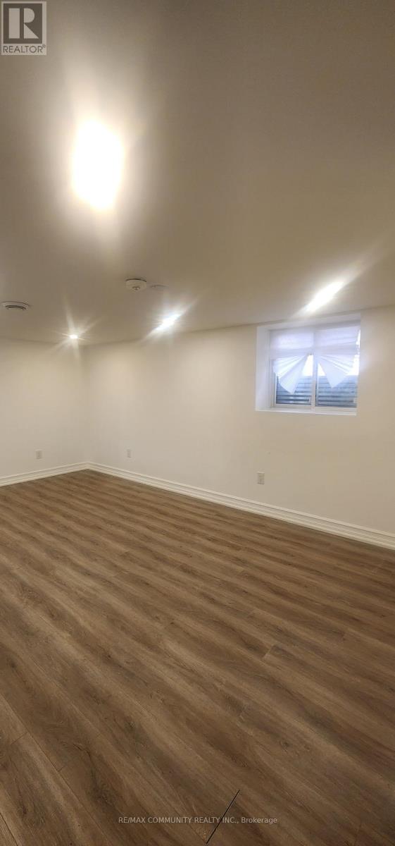 A room with wooden flooring and a window.