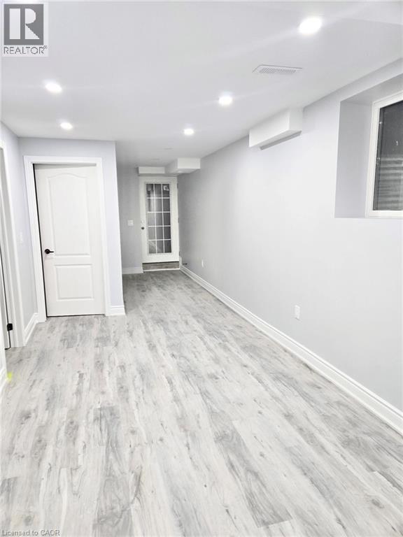 A room with a white door and a window with blinds.
