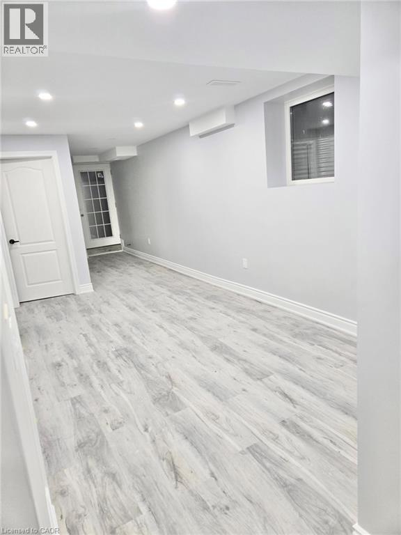 A room with a white door and a window with blinds.