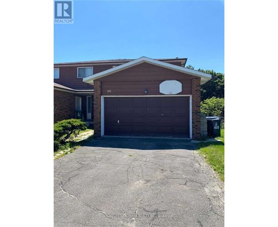 A house with a brown garage door and a white circular window above it.
