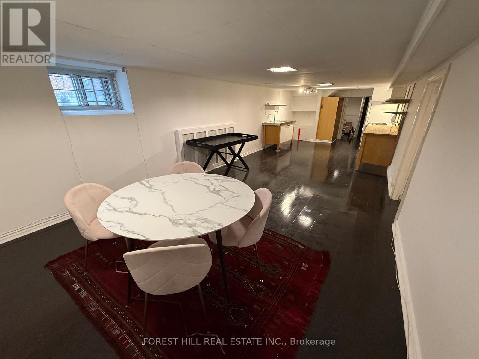 A dining room with a marble table and chairs.