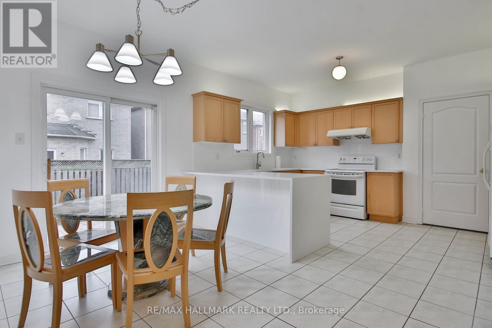 A kitchen with a table and chairs in the foreground.
