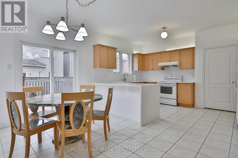 A kitchen with a table and chairs in the foreground.