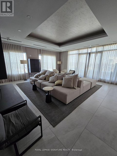 A modern living room with a large sectional sofa and a flat screen TV.