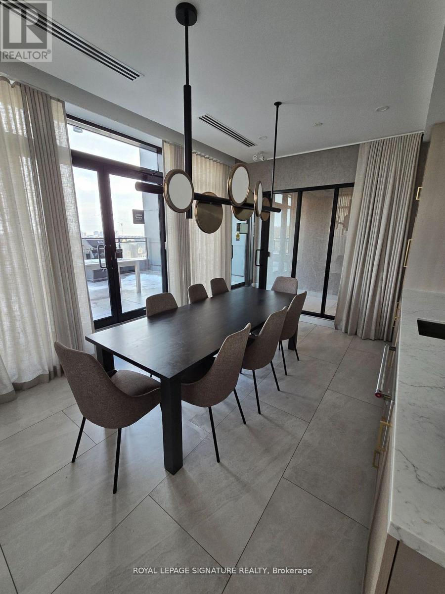 A dining room with a table and chairs.