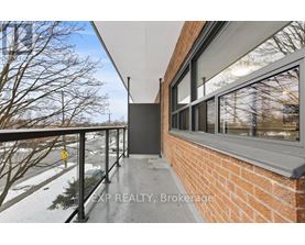 A balcony with a railing and a view of a snowy landscape.