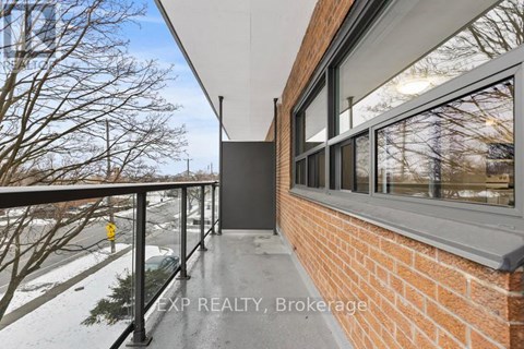 A balcony with a railing and a view of a snowy landscape.