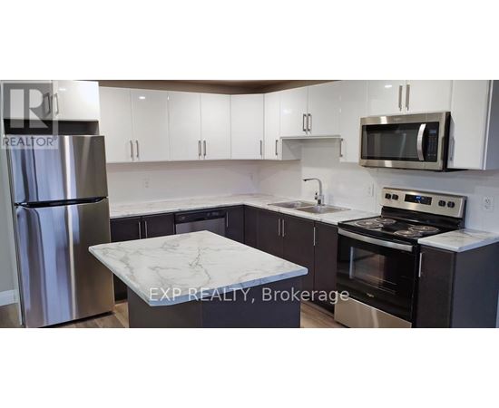 A kitchen with a marble countertop and stainless steel appliances.