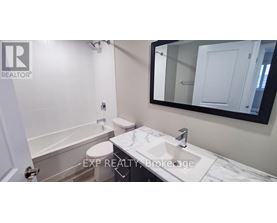 A bathroom with a toilet, sink, and mirror.